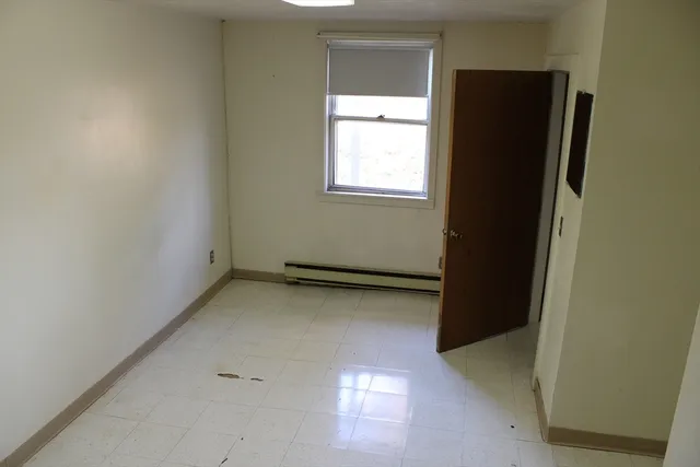 a view of an empty room and a window