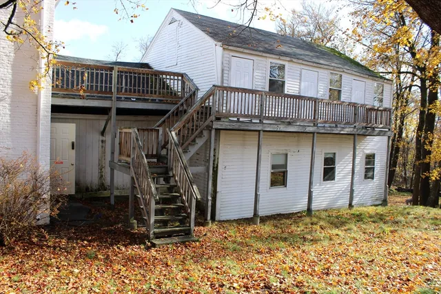 a view of a house with wooden fence