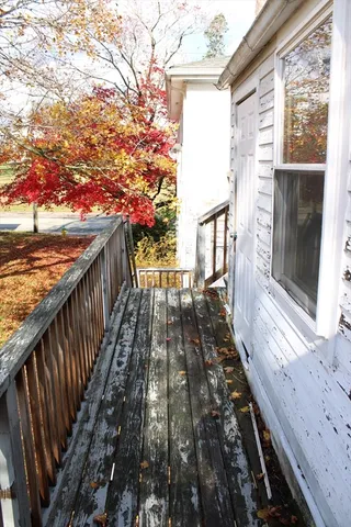 a view of balcony with wooden floor and fence