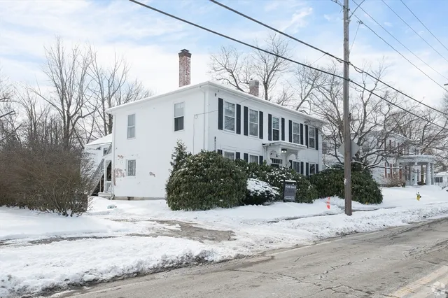a view of a house with snow on the road