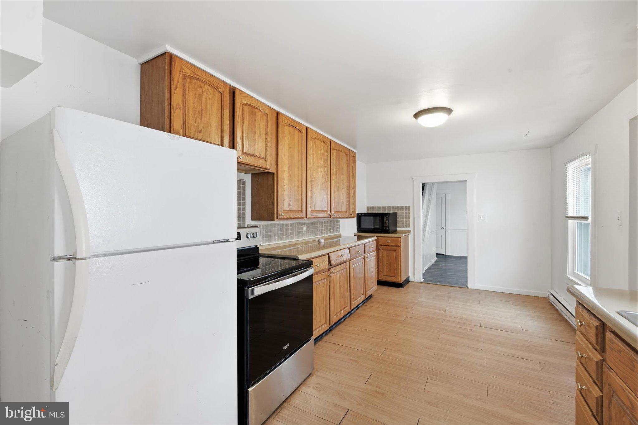 638 High Street Lancaster, PA 17603 - Photo 3 of 26 a kitchen with a refrigerator a stove top oven and cabinets