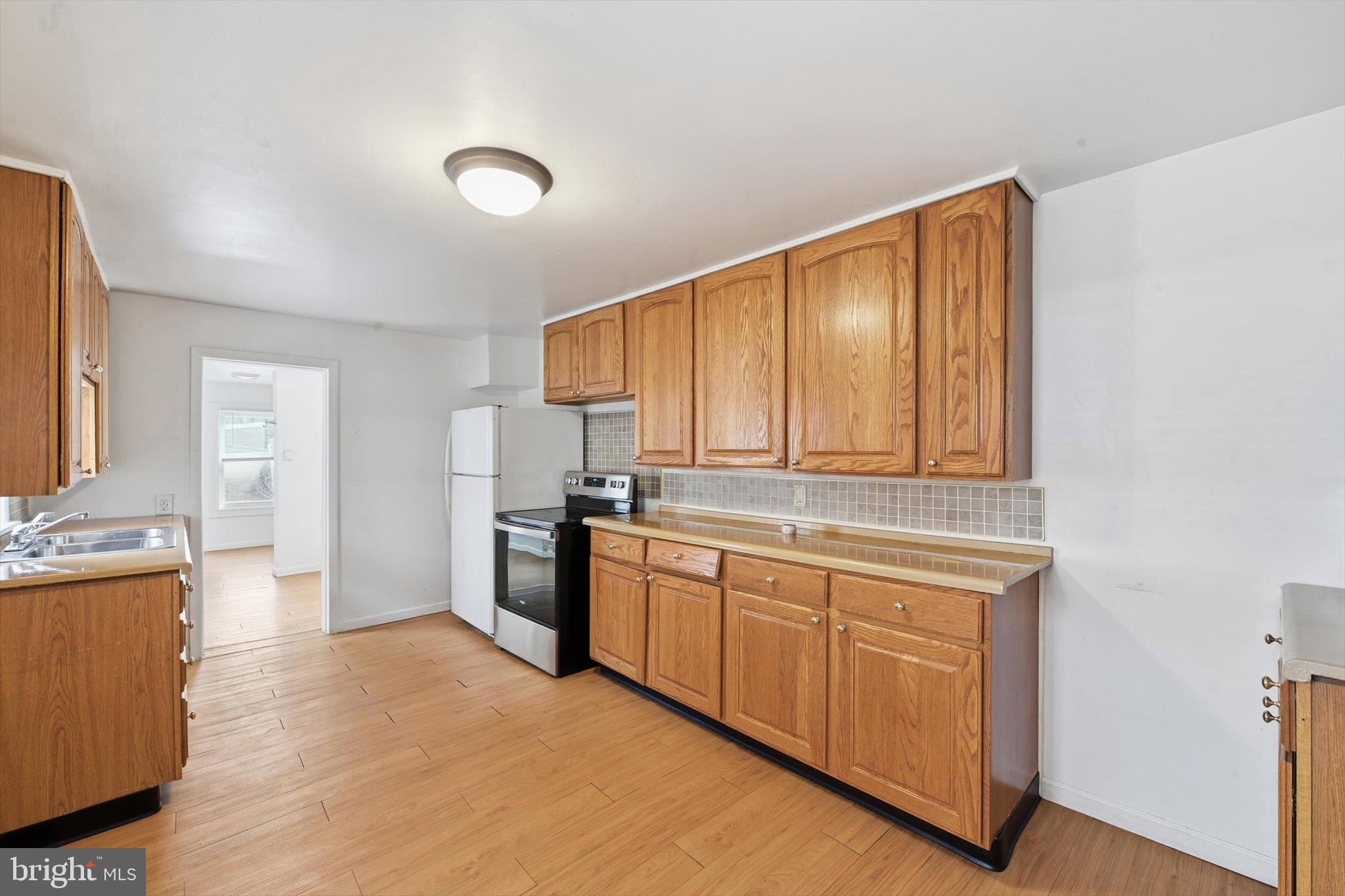 638 High Street Lancaster, PA 17603 - Photo 4 of 26 a kitchen with stainless steel appliances granite countertop a stove a sink and a refrigerator
