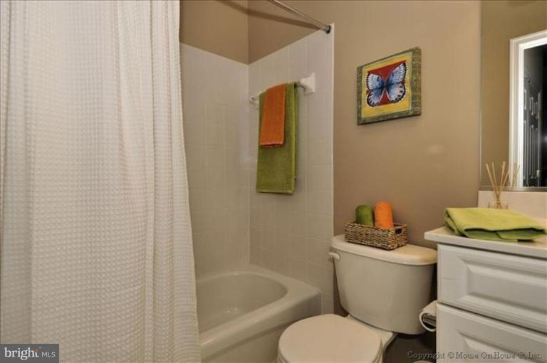 405 Main Street Gaithersburg, MD 20878 - Photo 12 of 23 a bathroom with a toilet and a sink