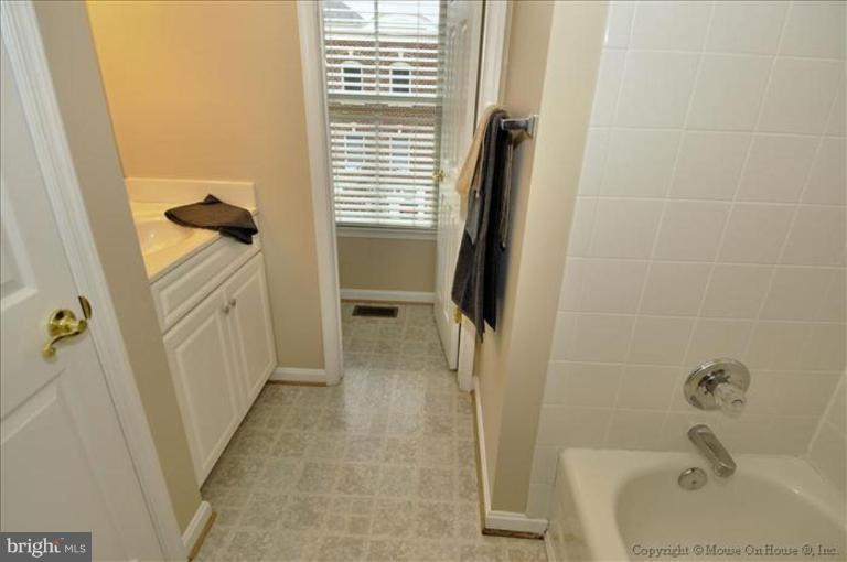 405 Main Street Gaithersburg, MD 20878 - Photo 15 of 23 a bathroom with a tub a sink and a shower