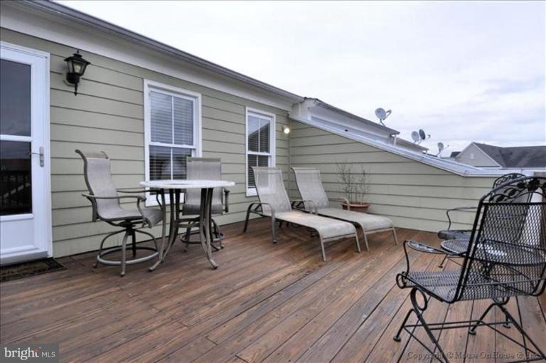405 Main Street Gaithersburg, MD 20878 - Photo 17 of 23 a view of a patio with table and chairs and wooden floor