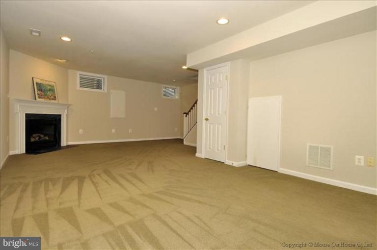 405 Main Street Gaithersburg, MD 20878 - Photo 18 of 23 a view of an empty room with a fireplace