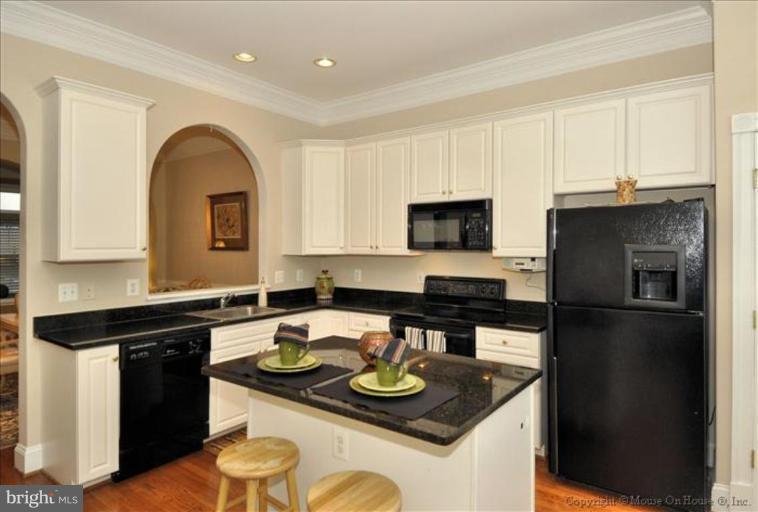 405 Main Street Gaithersburg, MD 20878 - Photo 6 of 23 a kitchen with stainless steel appliances granite countertop a sink a stove and refrigerator