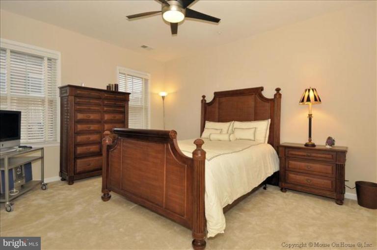 405 Main Street Gaithersburg, MD 20878 - Photo 8 of 23 a bedroom with a bed and a television