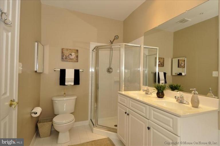 405 Main Street Gaithersburg, MD 20878 - Photo 9 of 23 a bathroom with a sink a toilet and shower