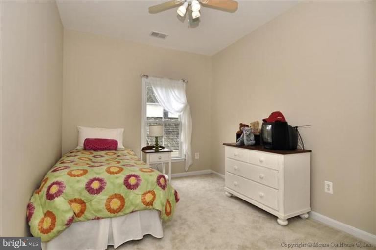 405 Main Street Gaithersburg, MD 20878 - Photo 10 of 23 a bedroom with a bed and a dresser next to a window