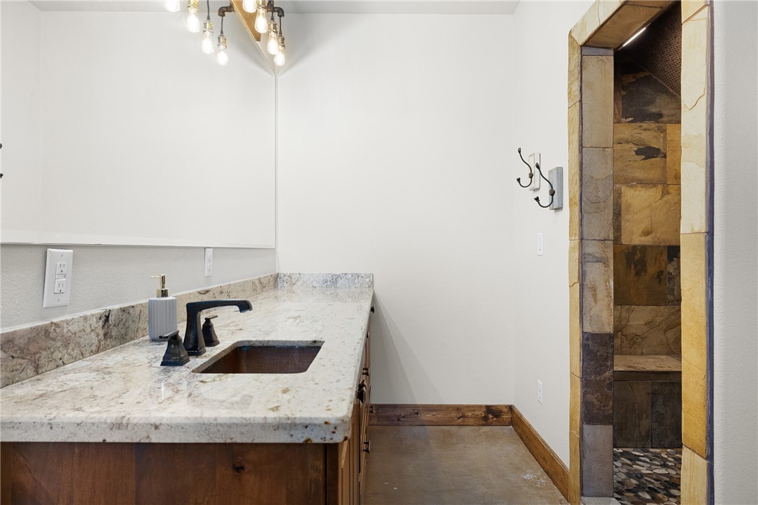 7440 Fm 39 Road South North Zulch, TX 77872 - Photo 25 of 50 a kitchen with a sink a refrigerator and cabinets