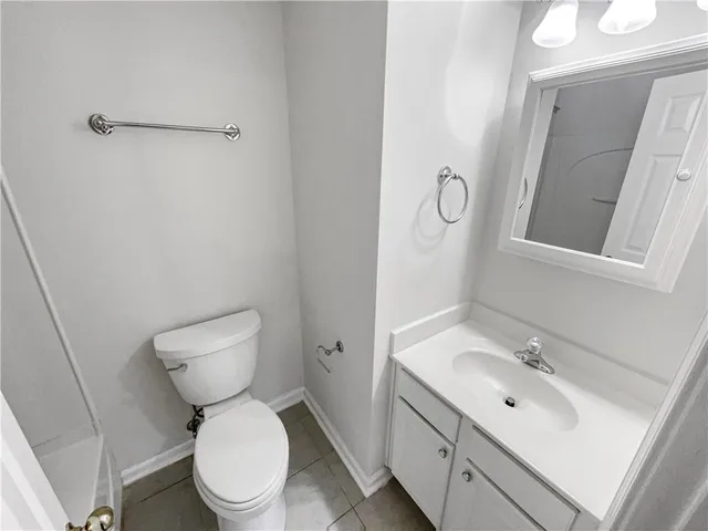 a white toilet sitting next to a bath tub