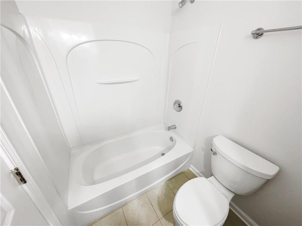 2225 Dillard Crossing Tucker, GA 30084 - Photo 13 of 41 a white toilet sitting next to a bath tub