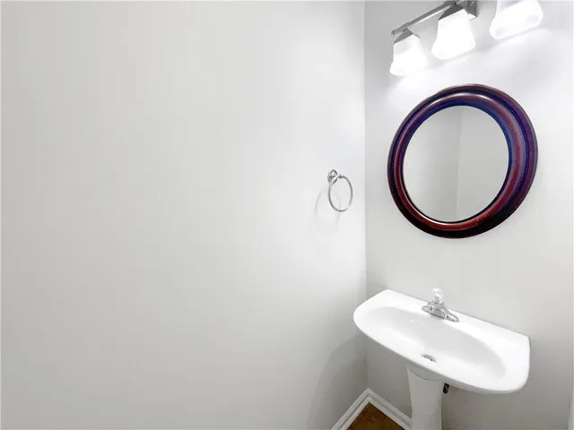 a large kitchen with stainless steel appliances granite countertop a sink and cabinets with wooden floor