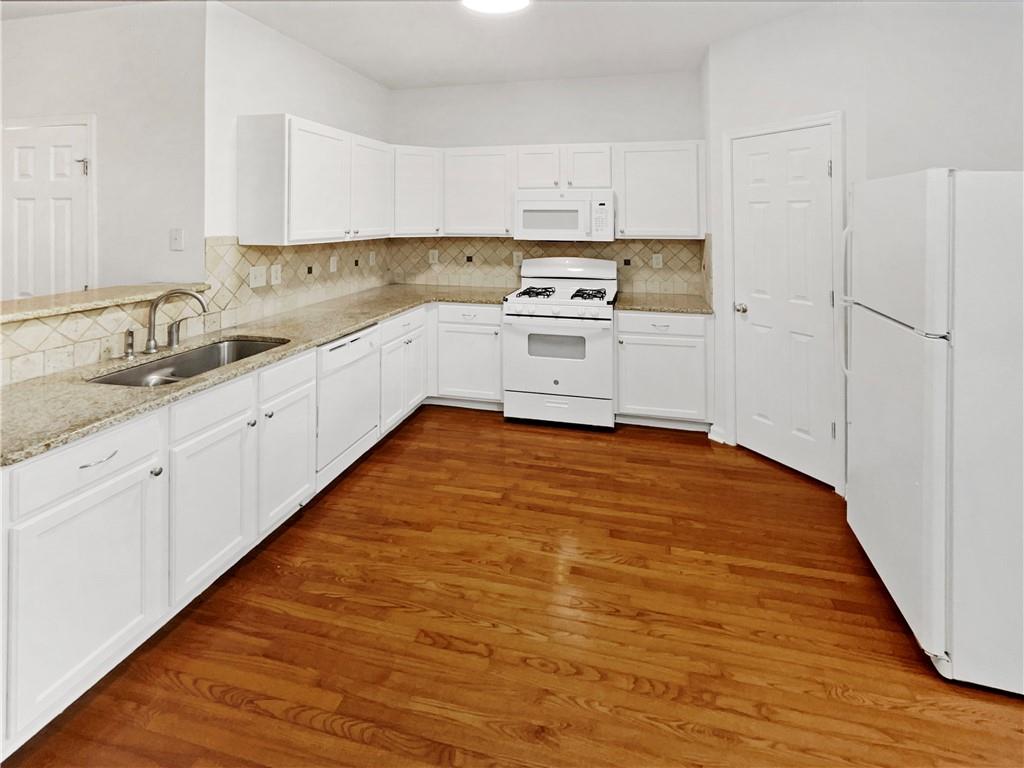 2225 Dillard Crossing Tucker, GA 30084 - Photo 18 of 41 a large white kitchen with white cabinets