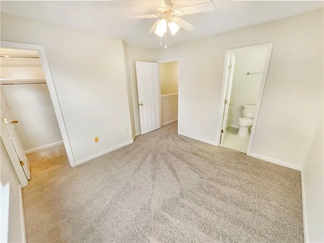 a white toilet sitting next to a bathroom sink