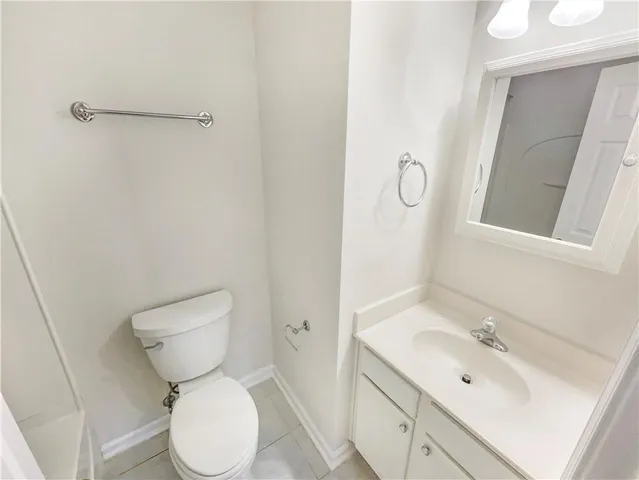 a white toilet sitting next to a bath tub