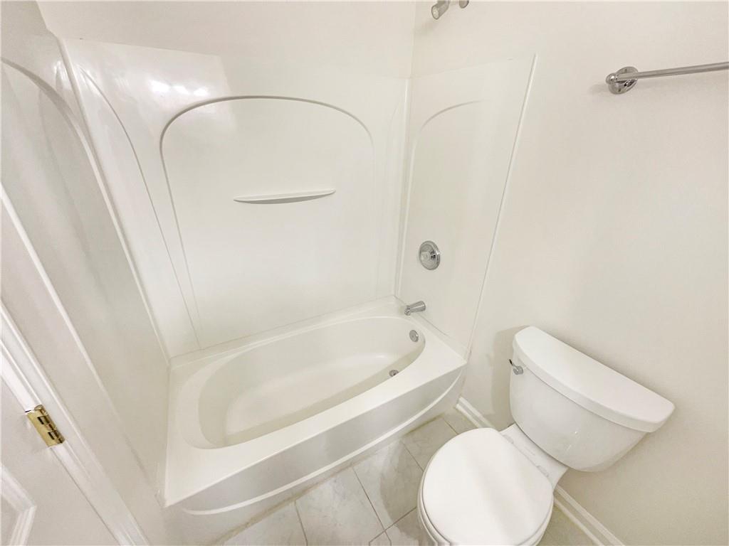 2225 Dillard Crossing Tucker, GA 30084 - Photo 28 of 41 a white toilet sitting next to a bath tub