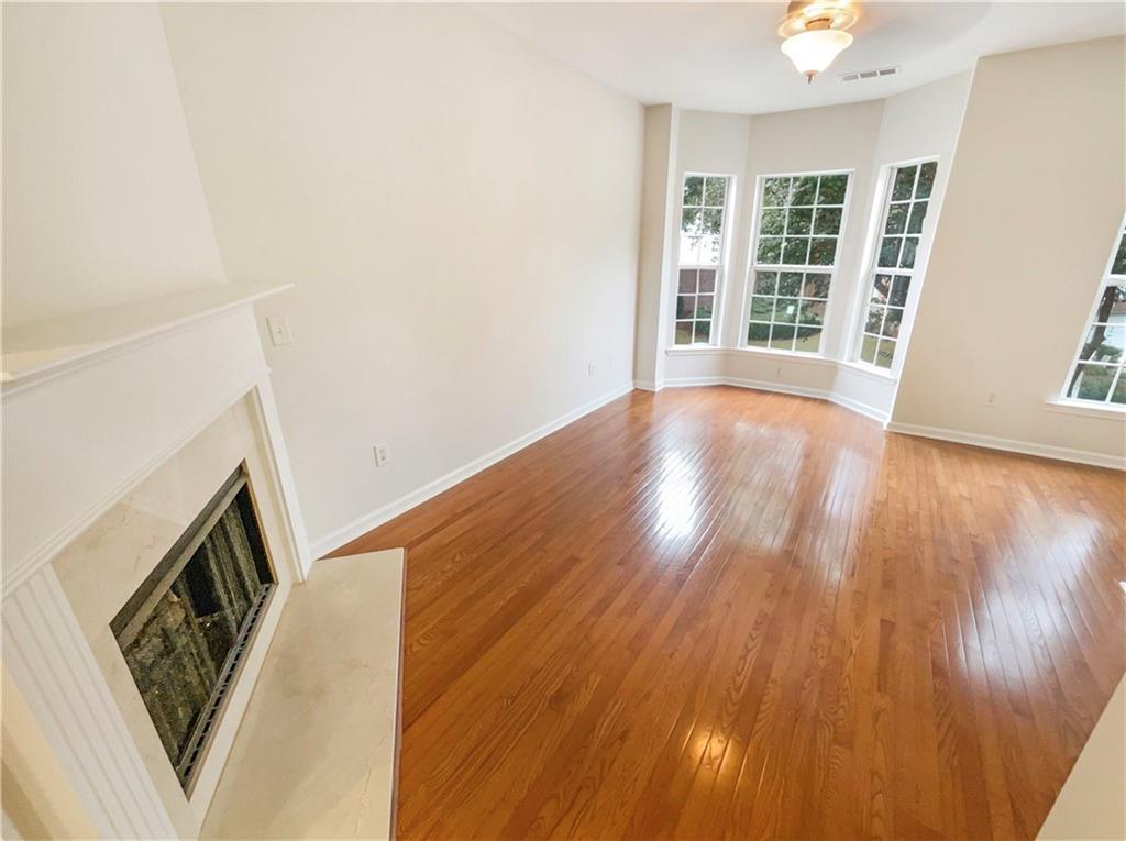 2225 Dillard Crossing Tucker, GA 30084 - Photo 29 of 41 wooden floor in an empty room with a window
