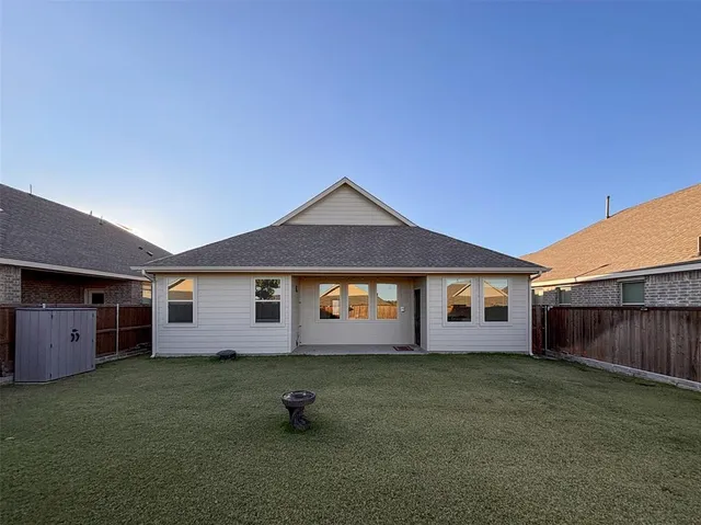 a kitchen with a sink cabinets and wooden floor