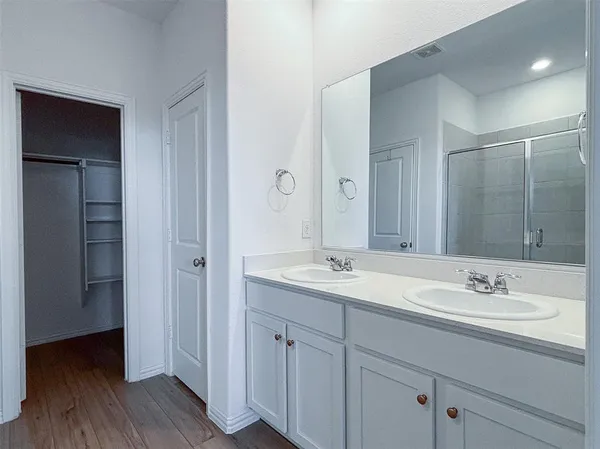 a bathroom with a sink double vanity and a mirror