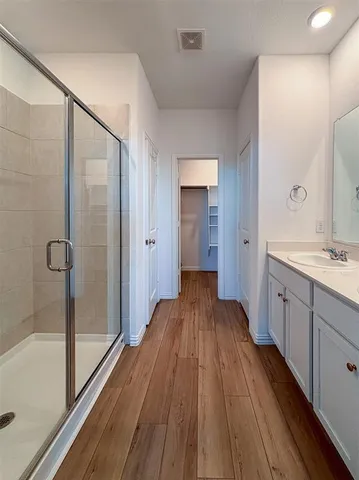 a spacious bathroom with a sink and a mirror