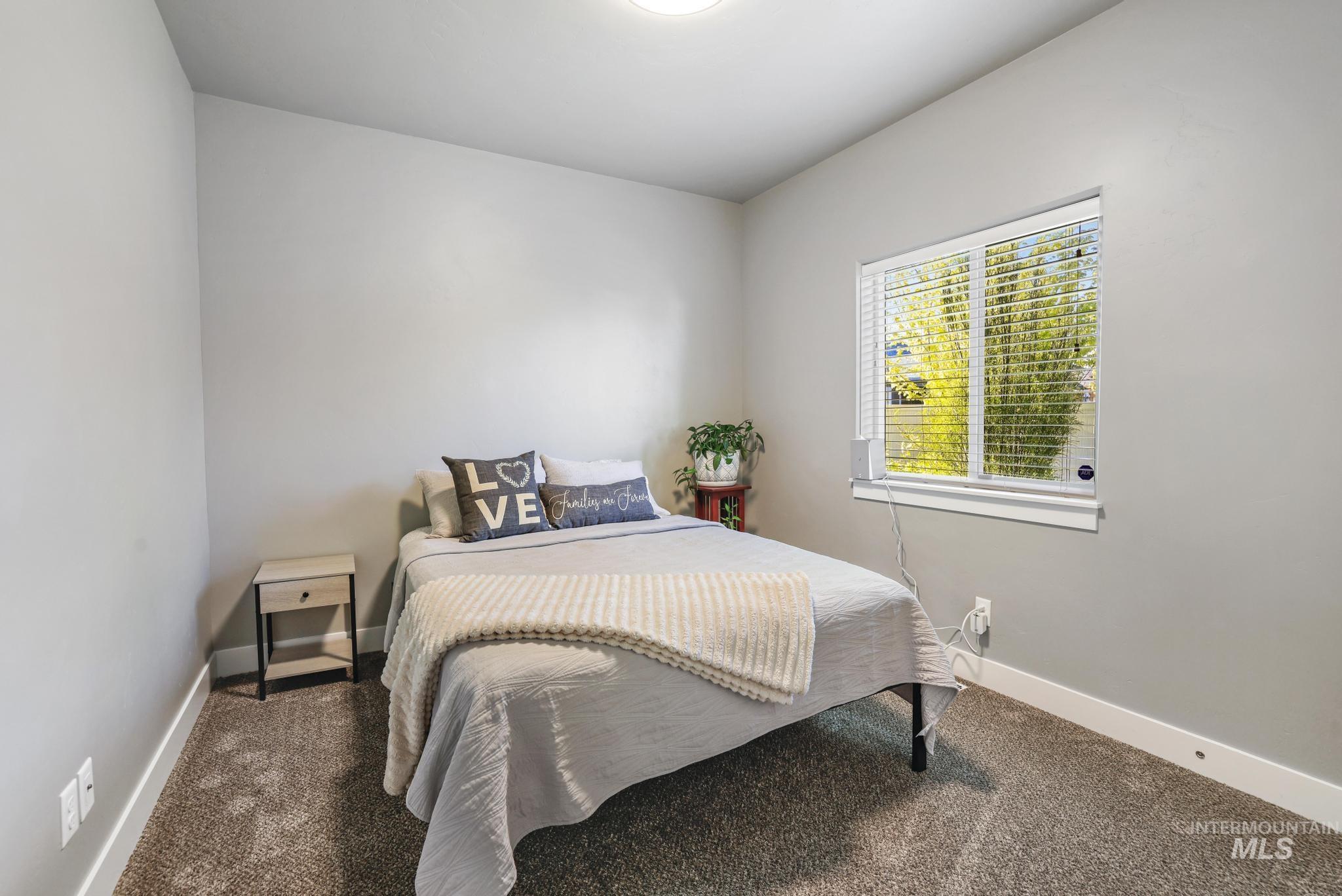 1050 Birchton Loop Twin Falls, ID 83301 - Photo 13 of 45 Carpeted interior room featuring light gray walls, a single window with blinds, and white baseboards
