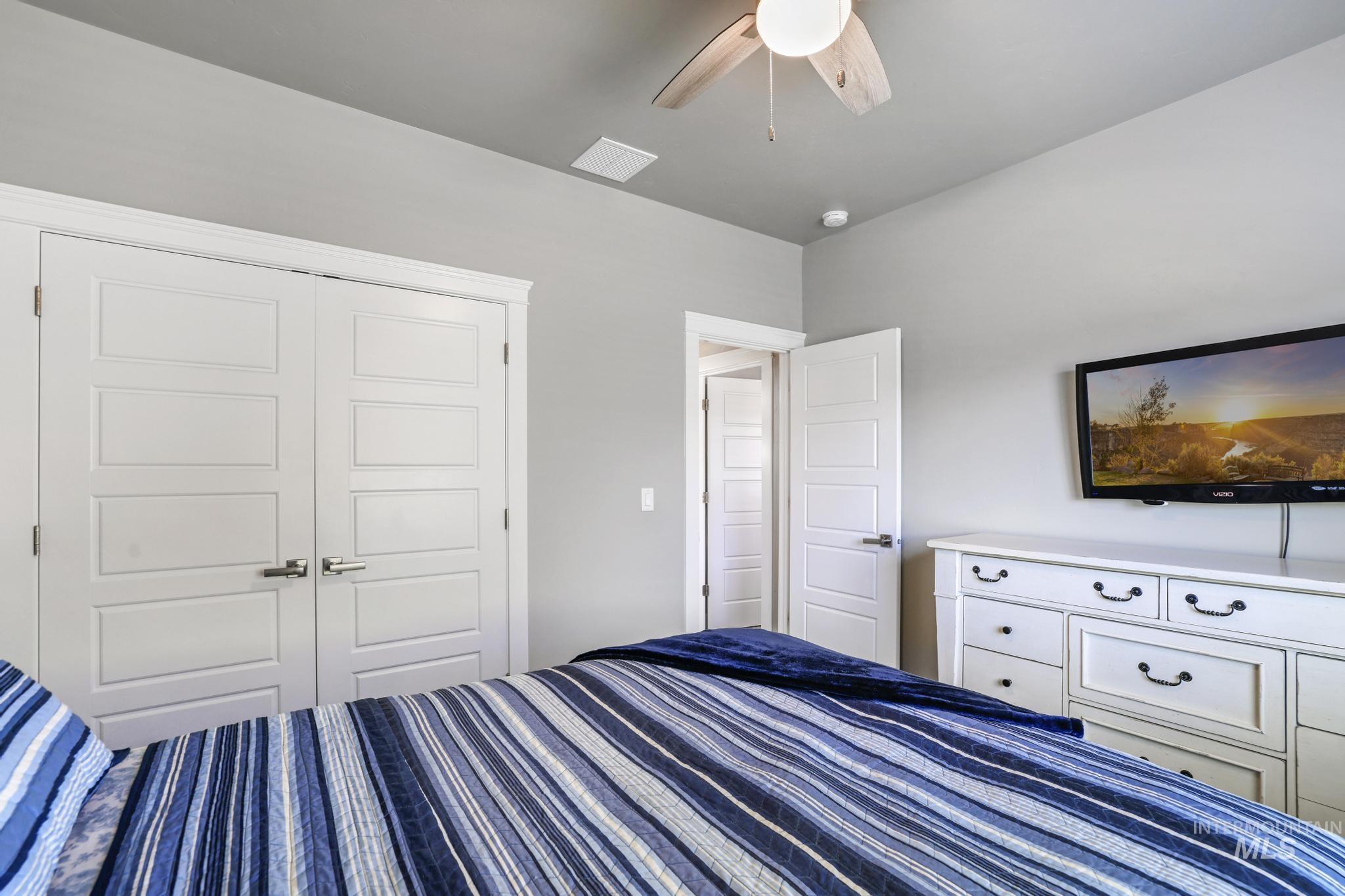 1050 Birchton Loop Twin Falls, ID 83301 - Photo 16 of 45 Interior bedroom featuring a ceiling fan with light fixture, light gray wall paint, and white trim