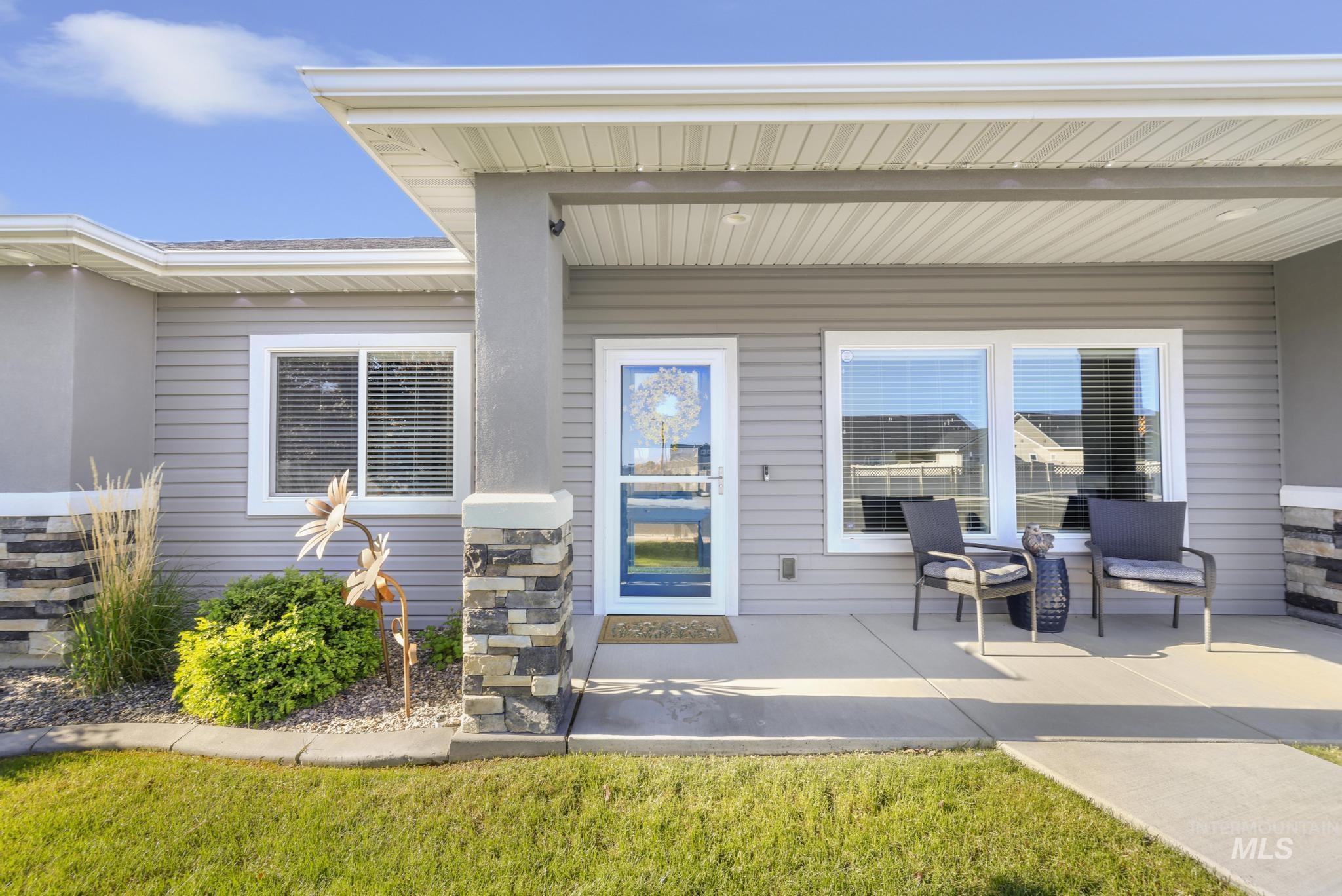 1050 Birchton Loop Twin Falls, ID 83301 - Photo 2 of 45 Welcoming front entry featuring a covered porch, stone accents, and a glass-paneled storm door