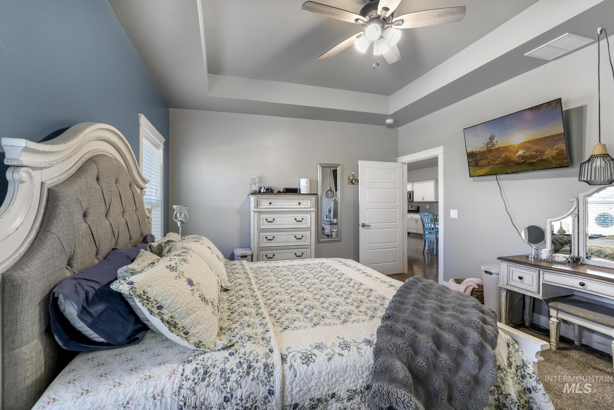 1050 Birchton Loop Twin Falls, ID 83301 - Photo 22 of 45 Tray ceiling detail with a ceiling fan light fixture