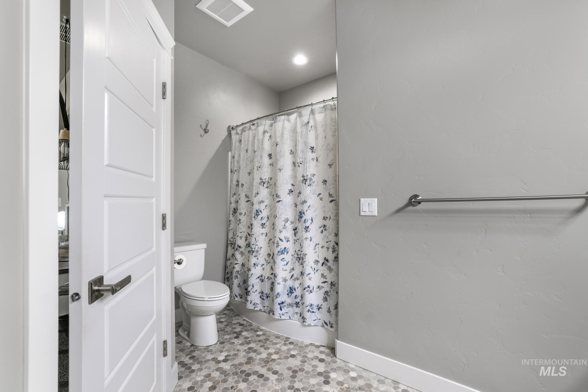 1050 Birchton Loop Twin Falls, ID 83301 - Photo 24 of 45 Bathroom featuring a shower area, toilet, and hexagonal tile flooring