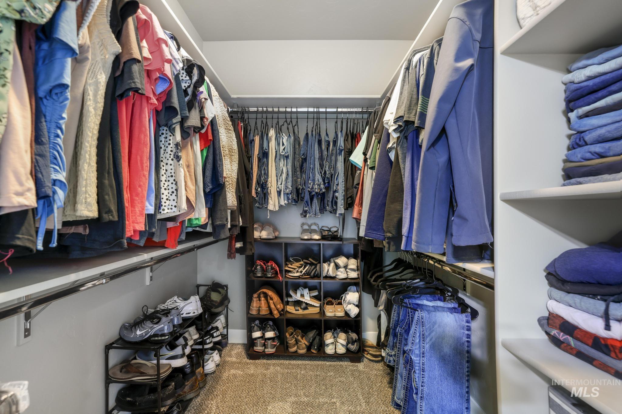 1050 Birchton Loop Twin Falls, ID 83301 - Photo 25 of 45 Walk-in closet featuring built-in shelving, hanging rods, recessed lighting, and carpet flooring