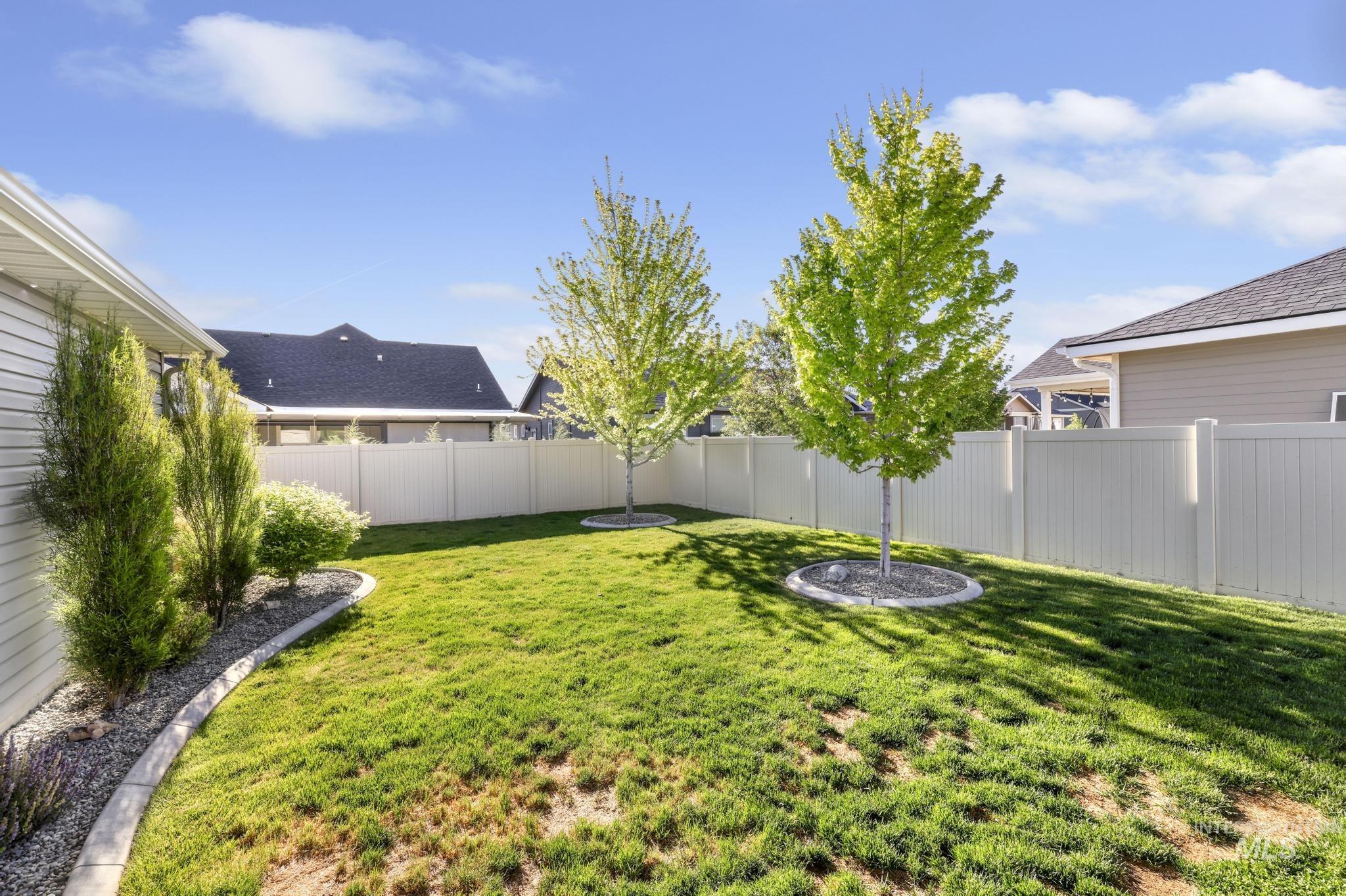 1050 Birchton Loop Twin Falls, ID 83301 - Photo 27 of 45 Expansive backyard featuring a manicured lawn and two mature trees