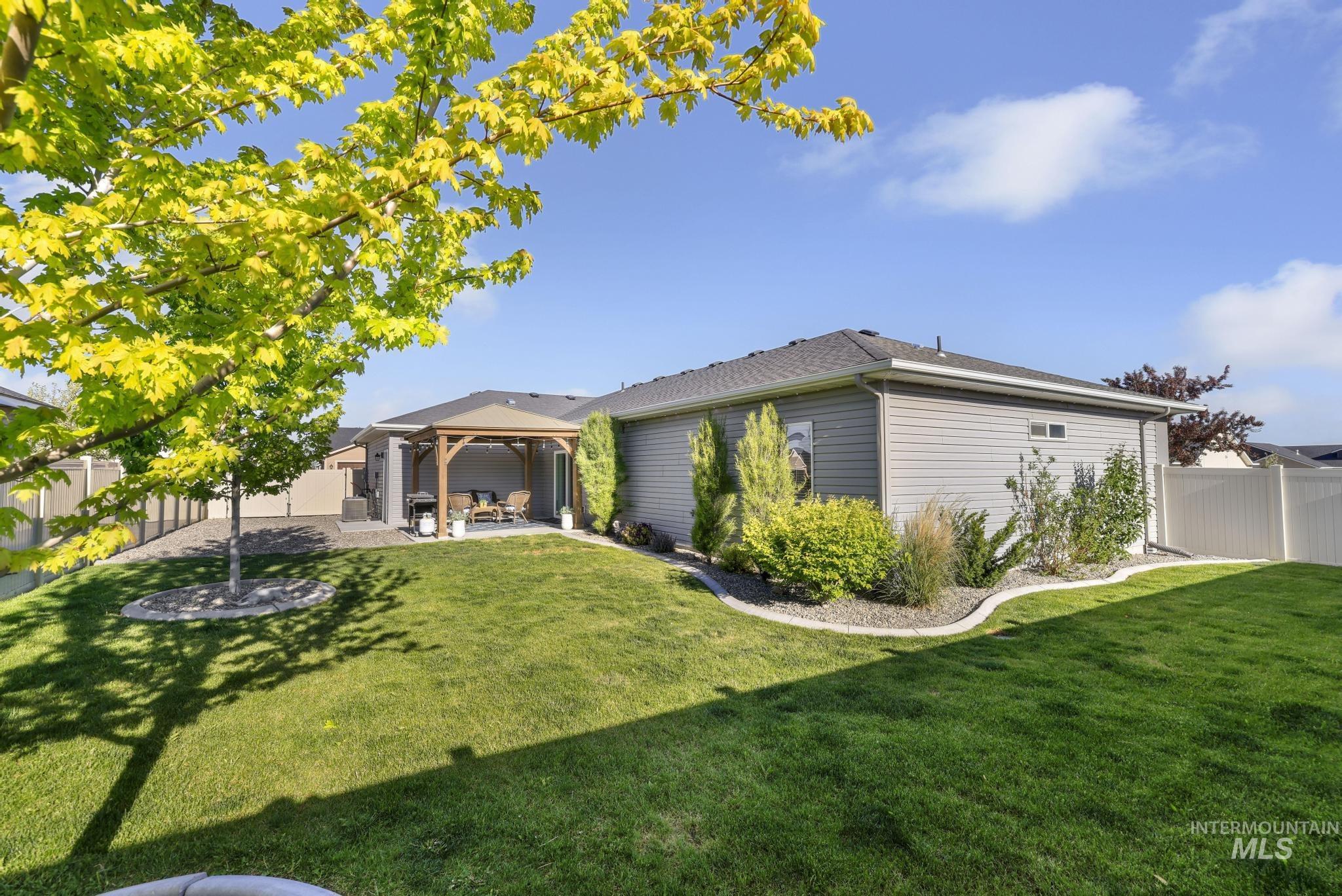 1050 Birchton Loop Twin Falls, ID 83301 - Photo 28 of 45 Expansive backyard featuring a manicured lawn, a detached gazebo with a wood frame, and a concrete patio