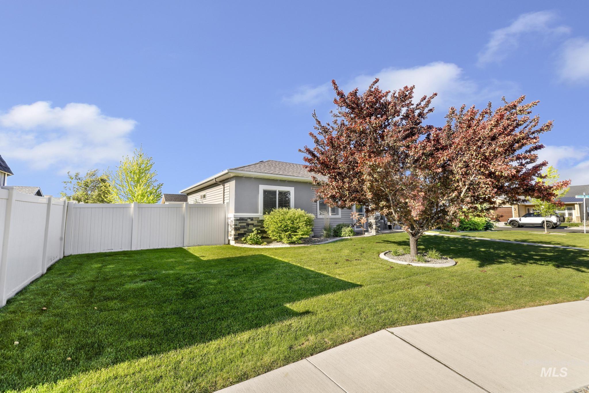 1050 Birchton Loop Twin Falls, ID 83301 - Photo 30 of 45 Expansive front yard featuring a verdant lawn, mature deciduous tree, and concrete sidewalk