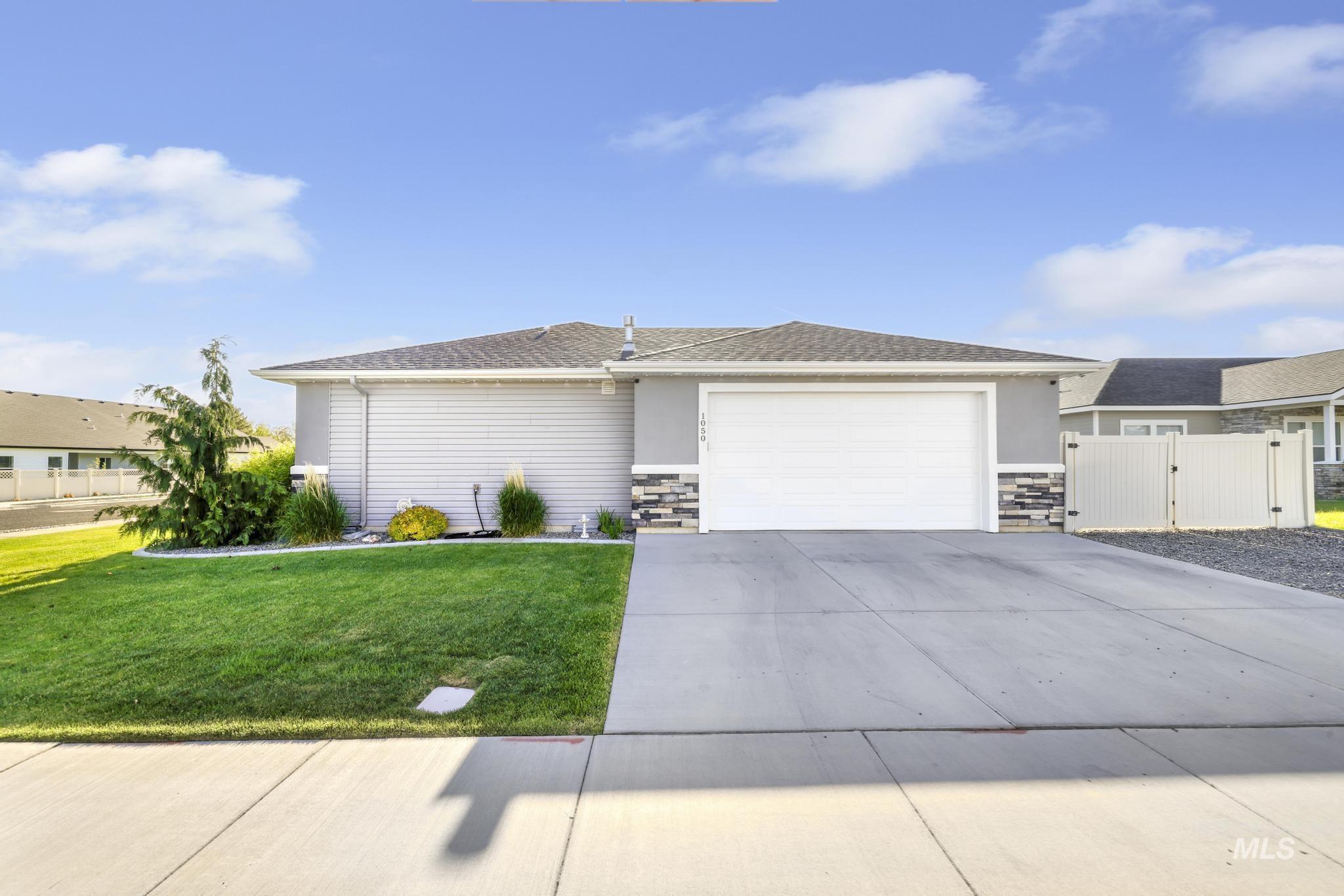 1050 Birchton Loop Twin Falls, ID 83301 - Photo 32 of 45 Single-story residence featuring a two-car garage, stone veneer accents, and a light gray exterior
