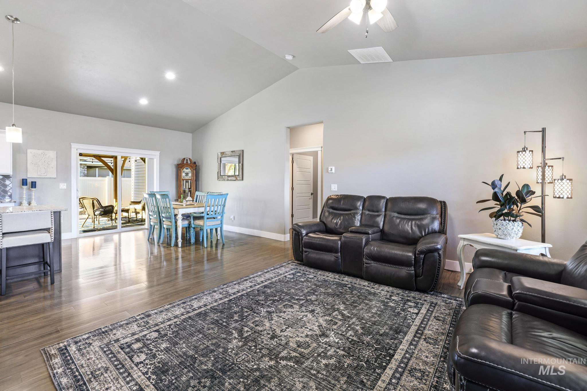 1050 Birchton Loop Twin Falls, ID 83301 - Photo 5 of 45 Spacious open-concept living area featuring vaulted ceilings, recessed lighting, and wood-finish flooring