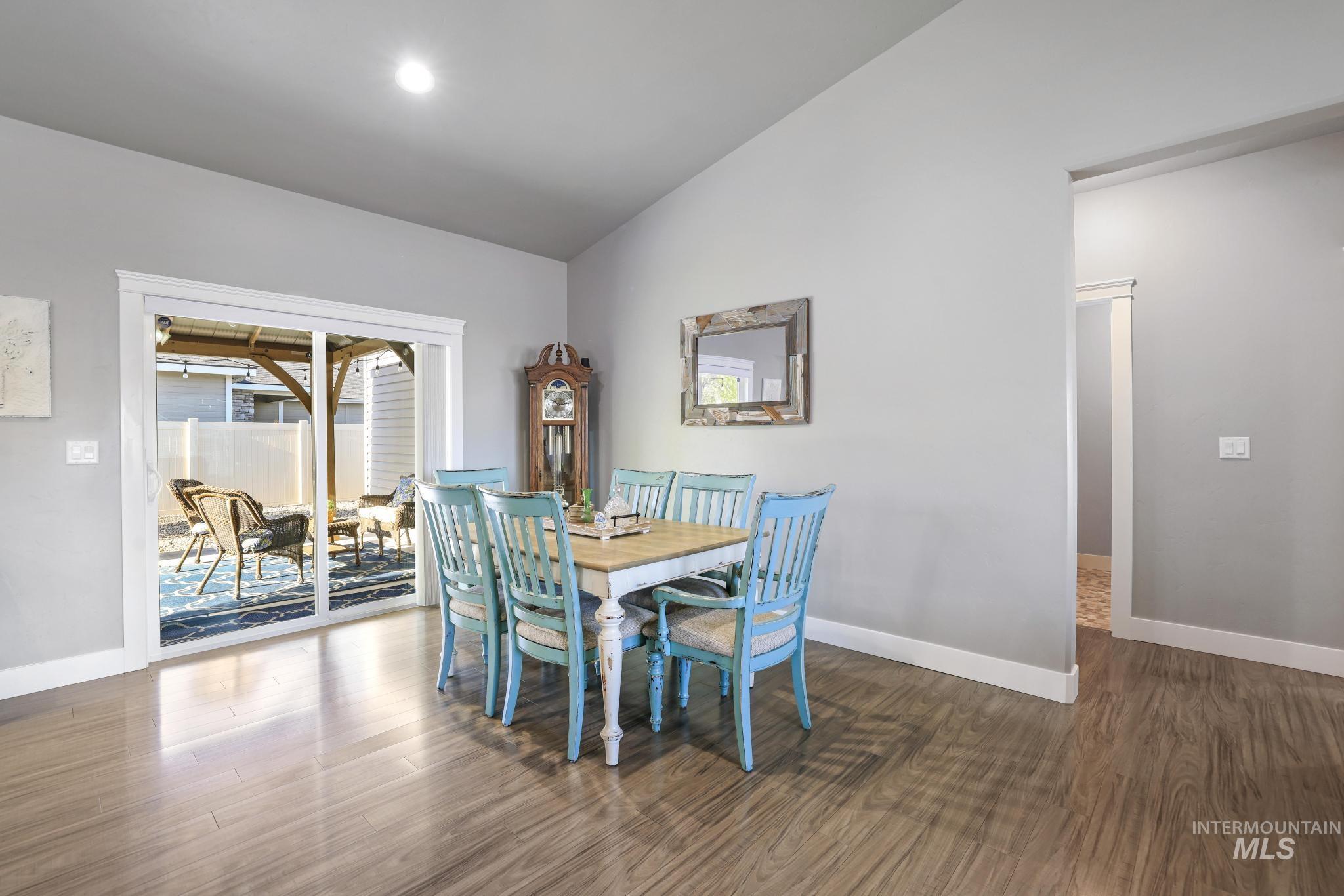 1050 Birchton Loop Twin Falls, ID 83301 - Photo 7 of 45 Dining area featuring wood-finish flooring, light gray walls, and white baseboards