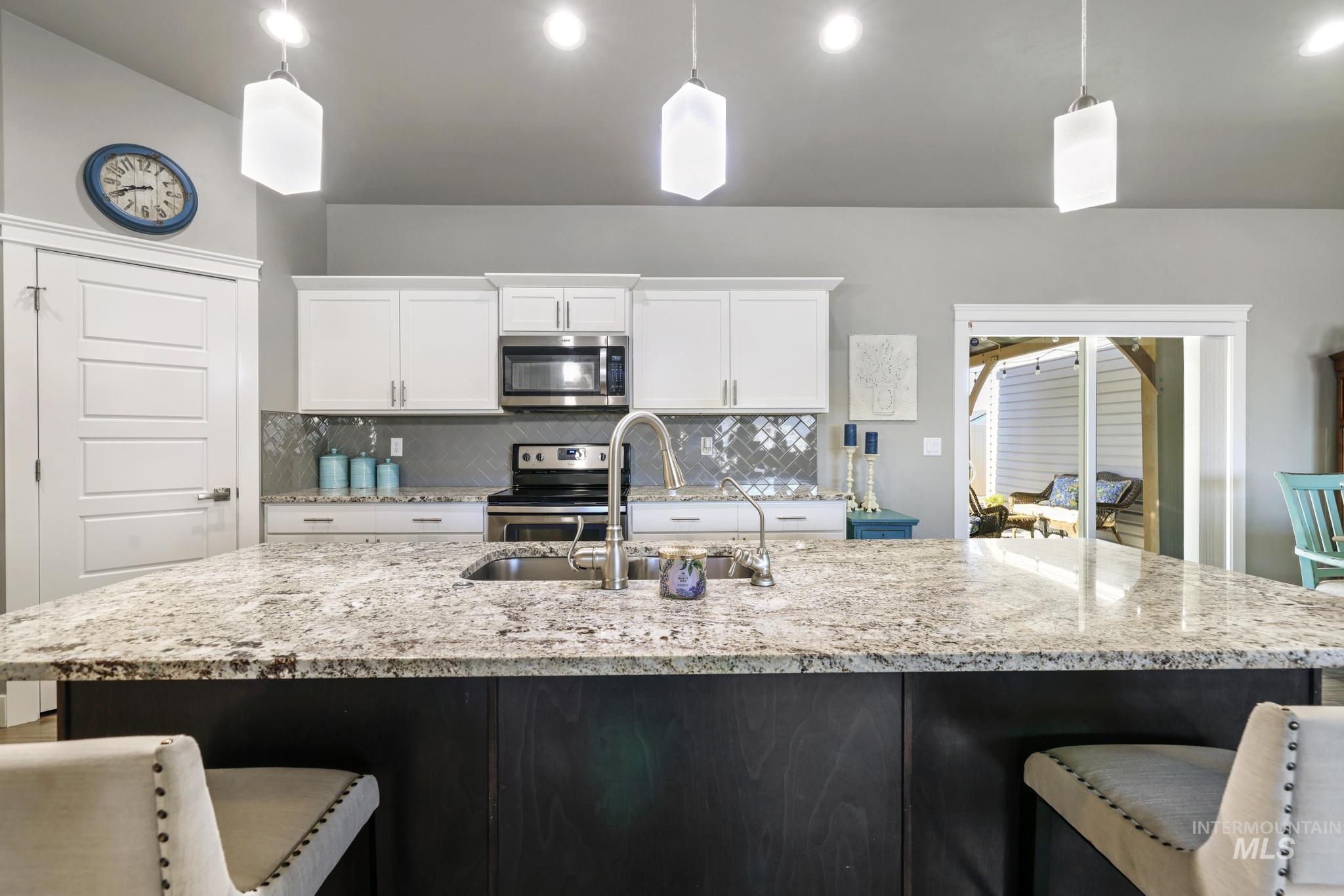 1050 Birchton Loop Twin Falls, ID 83301 - Photo 8 of 45 Expansive kitchen island featuring a granite countertop with integrated sink