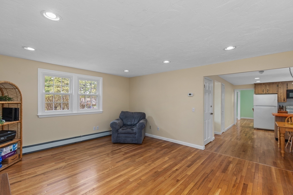 15 Massasoit Circle Walpole, MA 02032 - Photo 11 of 34 an empty room with wooden floor and windows