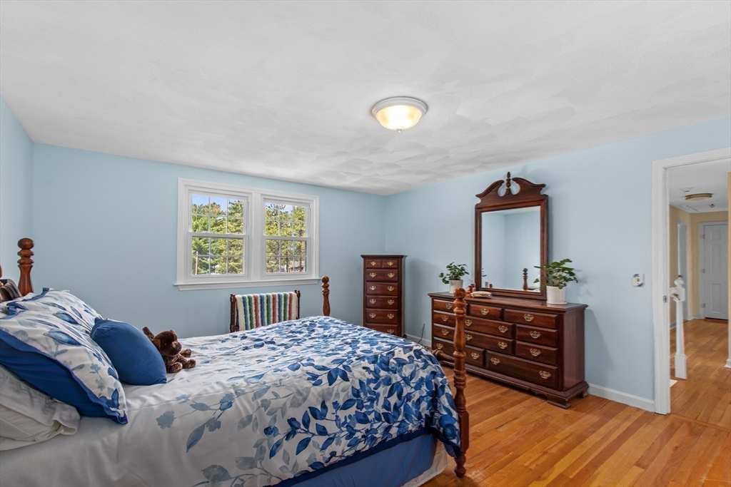 15 Massasoit Circle Walpole, MA 02032 - Photo 13 of 34 a bedroom with a bed and a table