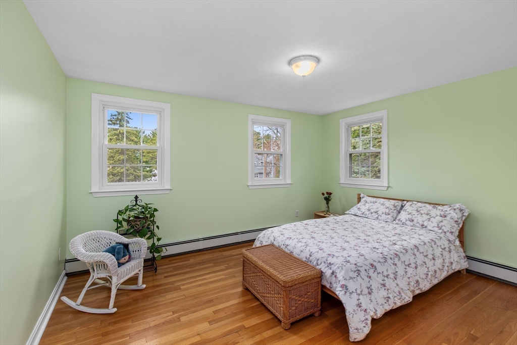 15 Massasoit Circle Walpole, MA 02032 - Photo 16 of 34 a bedroom with a bed and a chair