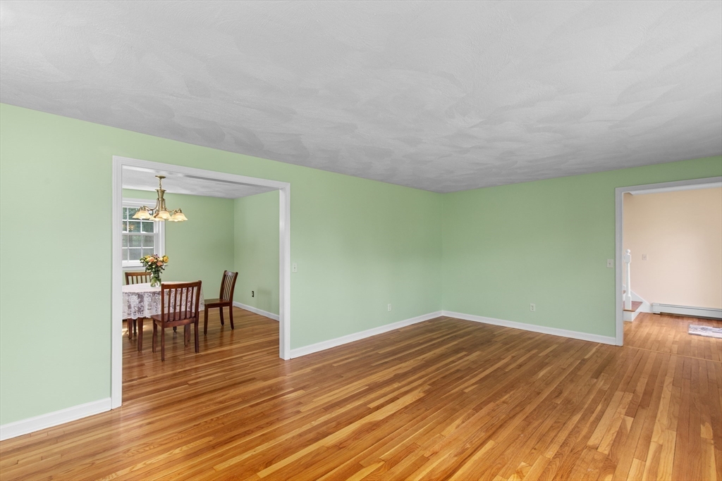15 Massasoit Circle Walpole, MA 02032 - Photo 5 of 34 a view of a room with wooden floor lounge chair and a fireplace