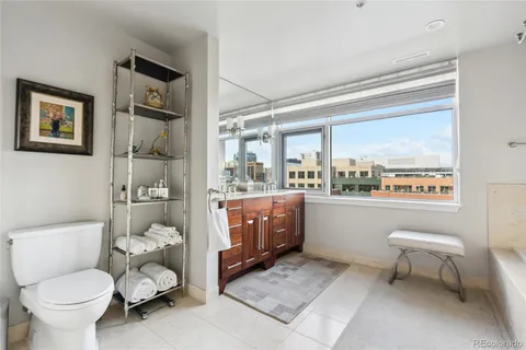 a spacious bathroom with a granite countertop sink and a large mirror