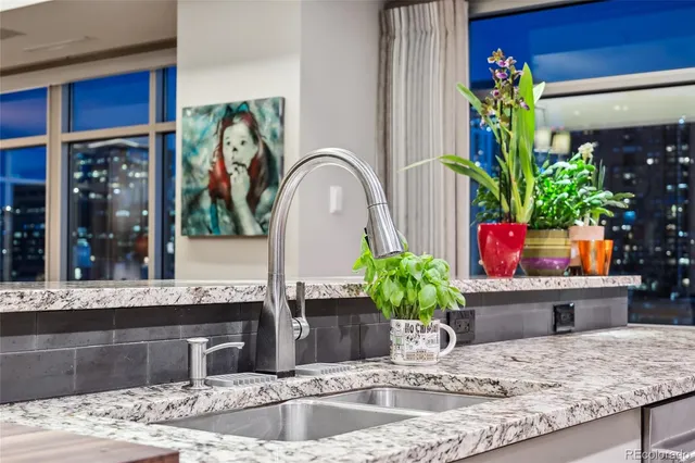 a living room with furniture kitchen view and a large window