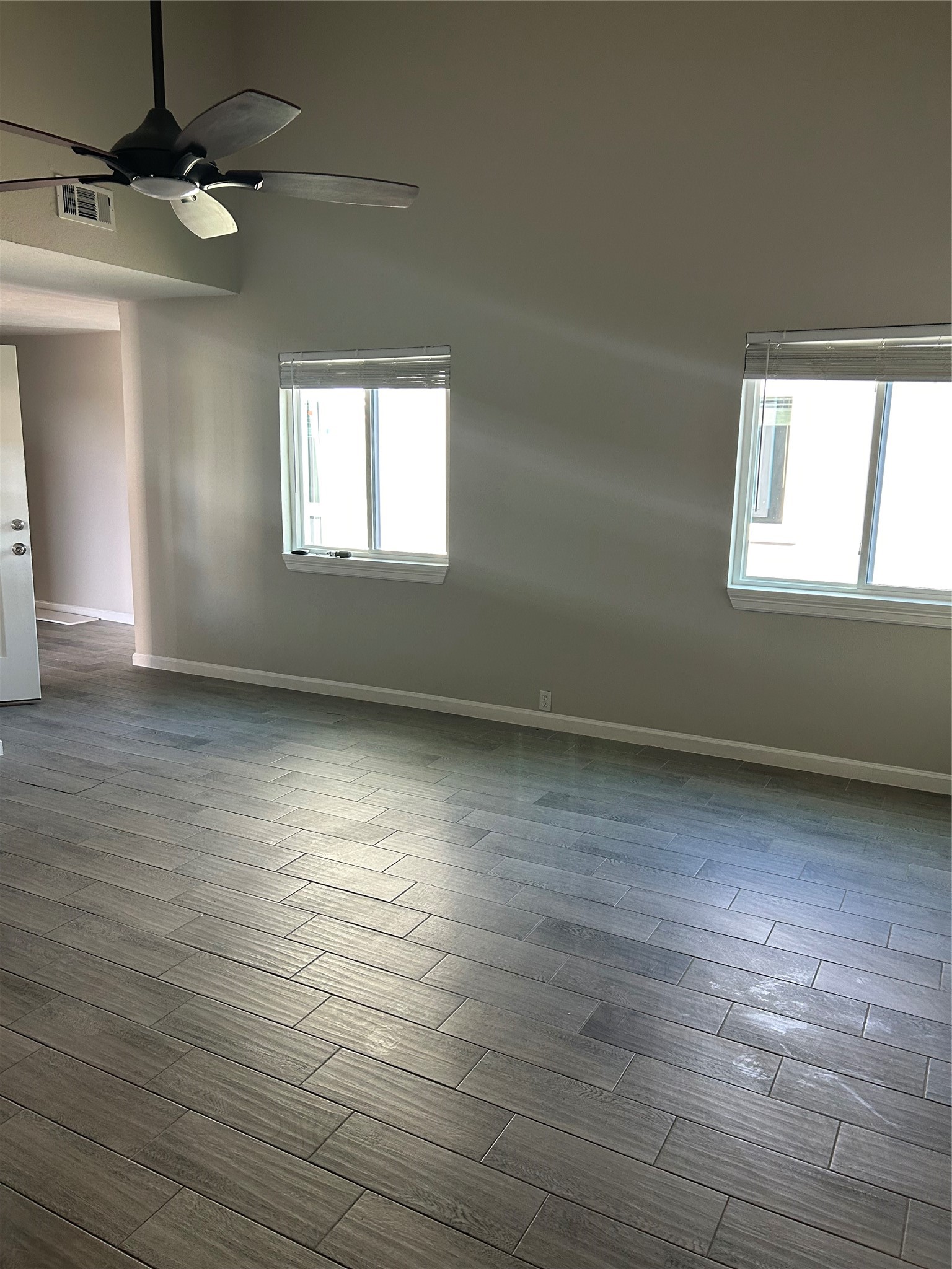 11719 Pender Lane Houston, TX 77477 - Photo 8 of 21 an empty room with wooden floor and windows