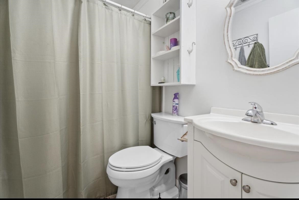 507 Gerona Road St. Augustine, FL 32086 - Photo 9 of 23 a bathroom with a sink a toilet and shower curtain
