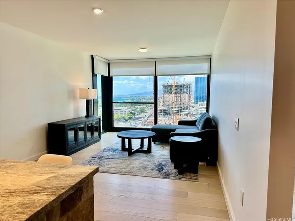 a living room with furniture and a floor to ceiling window