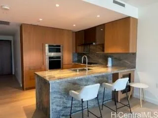 a kitchen with stainless steel appliances granite countertop a sink and a refrigerator