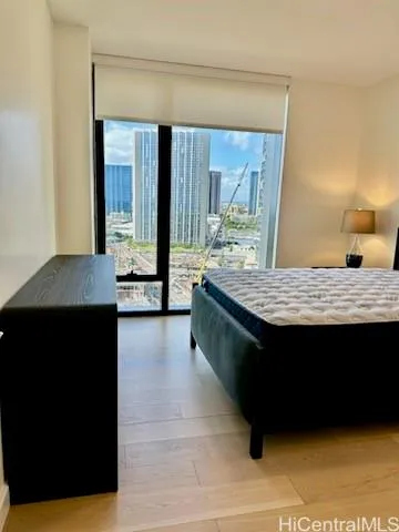 a view of kitchen island with granite countertop wooden cabinets a sink and a wooden floor